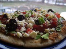 Pita Pizzas With Hummus, Spinach, Olives, Tomatoes & Cheese
